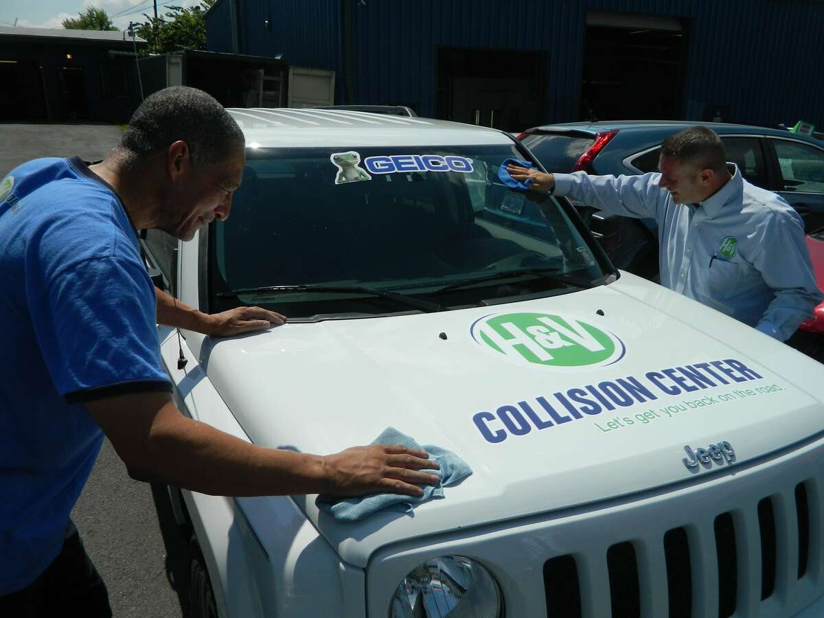 Repair technicians at H&V Collision Center put the finishing touches on one of three refurbished vehicles that will be donated to local veterans on Saturday. (H&V Collision Center)