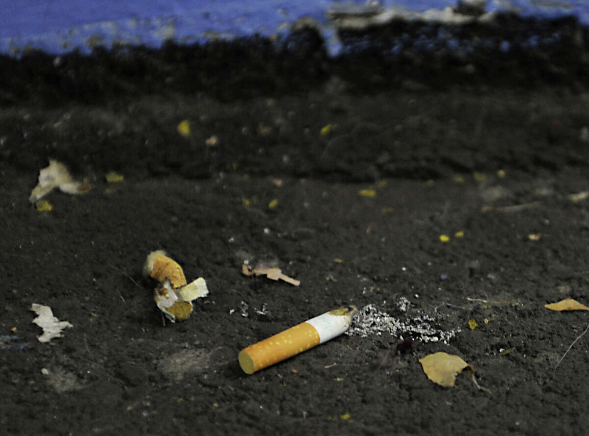 FILE - In this Feb. 3, 2016, cigarette butts are seen by the elevators in the Empire State Plaza parking garage in Albany, N.Y.