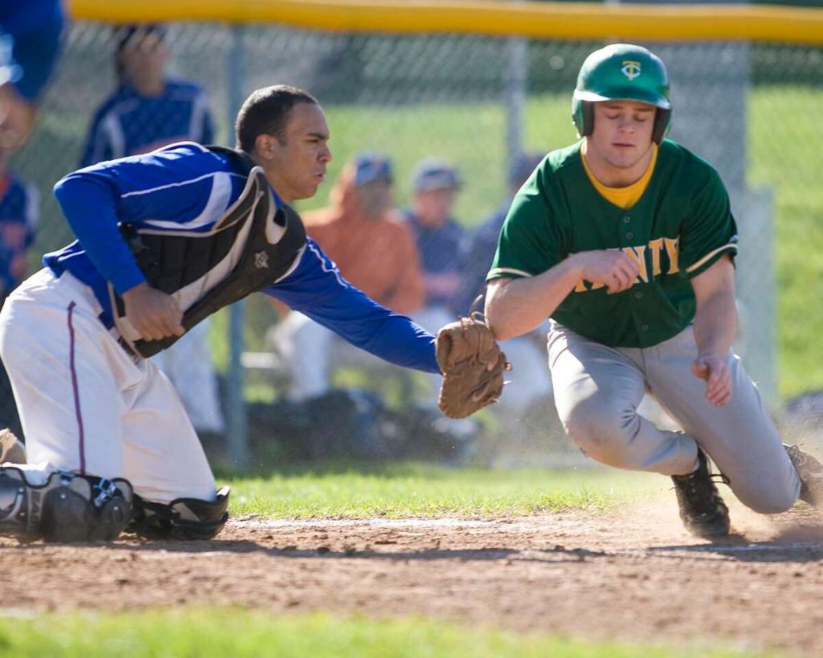 Danbury catcher Austin Calitro tags out Trinity Catholic's Jamie Antonetti at the plate Thursday at Danbury High. Antonetti was gunned out on a throw by Hatters leftfielder Brian Deldebbio.