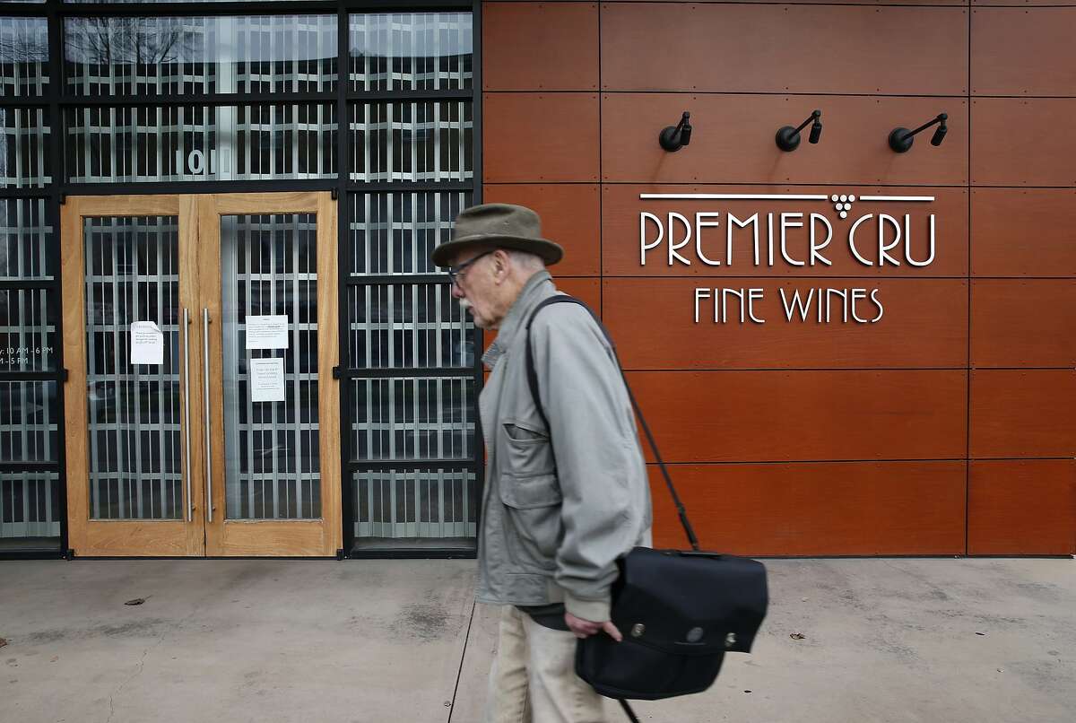 A man walks past the shuttered Premier Cru wine store on University Avenue in Berkeley, Calif. on Thursday, Jan. 14, 2016. Owners of the wine futures business filed for bankruptcy leaving customers in the lurch.