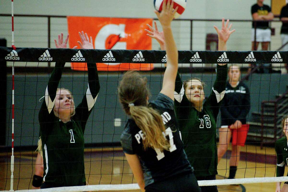 John Cooper School's Kaylee Frazier (1) and Kayley Wood (16) try to block a shot by Pearland's Sarah Wright (17) at the Adidas Texas Volleyball Invitational Thursday, Aug. 11.