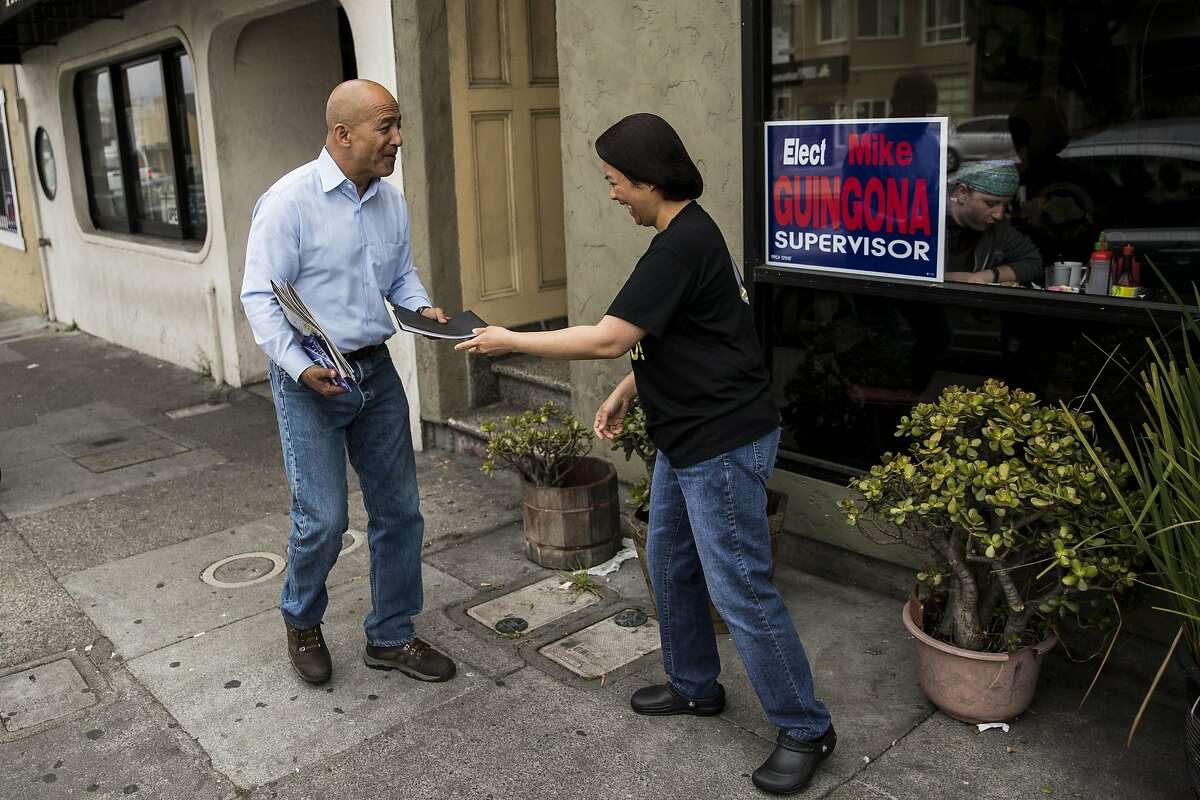 Daly City Council member Mike Guingona, left, who is running for San Mateo County Board of Supervisors, thanks a staff member of the Tselogs restaurant who ran out to return a belonging to him in Daly City, Calif. on Friday, Aug. 12, 2016. Guingona is the first Filipino-American councilman in Daly City where a third of its residents are of Filipino descent.