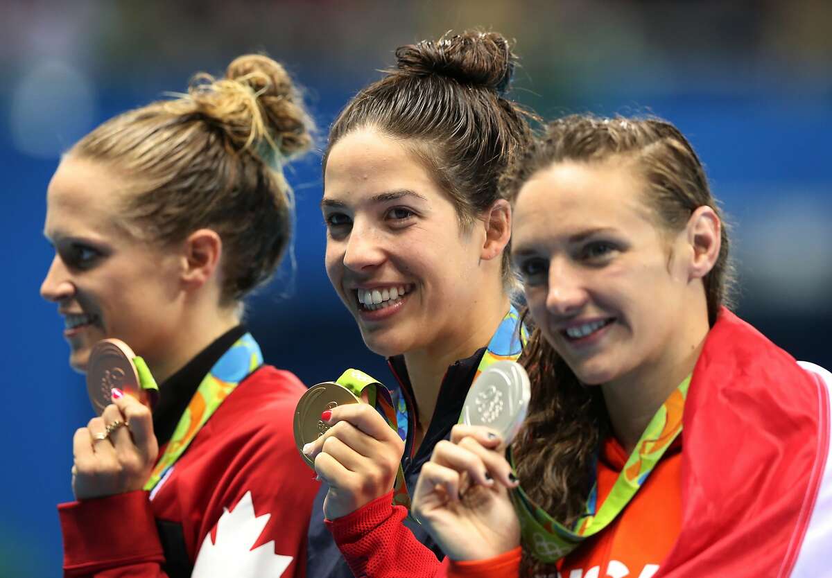 Canada's Hilary Caldwell, United States' Maya DiRado and Hungary's Katinka Hosszu, from left, in the women's 200-meter backstroke medals ceremony during the swimming competitions at the 2016 Summer Olympics, Friday, Aug. 12, 2016, in Rio de Janeiro, Brazil. (AP Photo/Lee Jin-man)