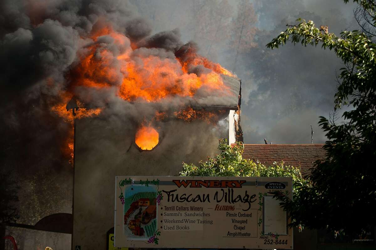 Flames tear through a building at the Tuscan Village/Terrill Cellars Winery as the Clayton Fire burns through downtown Lower Lake, Calif., on Sunday, Aug. 14, 2016.