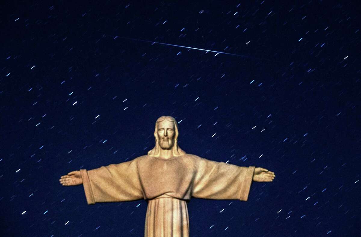 A Perseid meteor crosses the night sky over a statue of Jesus Christ in the village of Ivye some 125 km west of Minsk, on early August 13, 2016. To put one's hope in Him, then, is to believe despite all the evidence to the contrary Jesus' way of peace, justice, mercy and compassion will ultimately prevail over the empire's ways of violence, exploitation, oppression and fea  / AFP PHOTO / SERGEI GAPONSERGEI GAPON/AFP/Getty Images