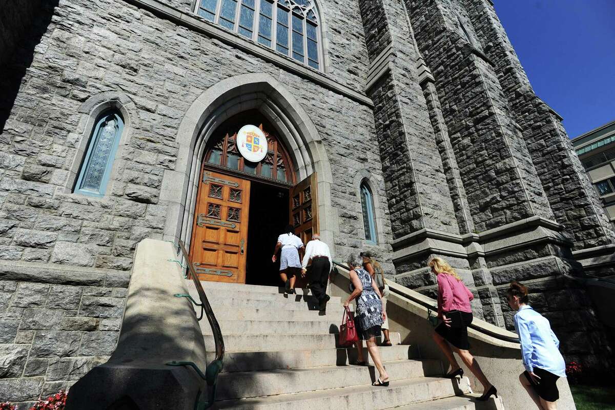 Parishioners files into the Basilica of St. John the Evangelist in downtown Stamford, Conn., for 10 a.m. mass on Sunday, August 14, 2016. The number of Americans who identify as Catholic has shrunk, but the attendance at Stamford's largest Catholic church is bucking the trend and is up six percent since 2013