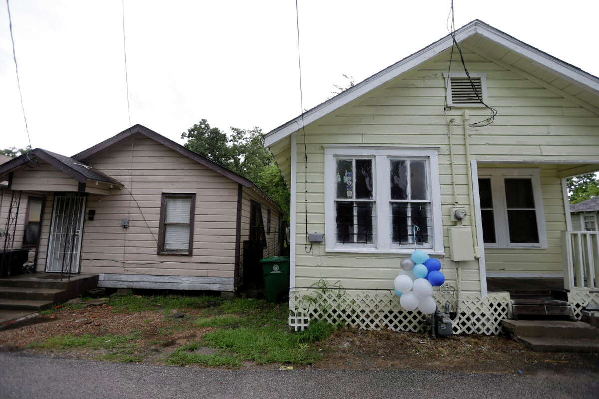 The house shown on right at 3011 Tierwester is the home of Sheborah Thomas, who was charged Sunday night with capital murder in the drowning deaths of her 7-year-old son, Araylon "Ray Ray" Thomas, and 5-year-old daughter, Kayiana Thomas, shown Monday, Aug. 15, 2016, in Houston. The children bodies where hidden under the neighbor's house on the left.