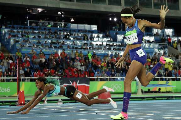 Shaunae Miller, left, of the Bahamas takes a painful route to Olympic glory by falling over the finish line to win the women's 400 meters and deny Allyson Felix of the U.S. a record-setting fifth gold medal.