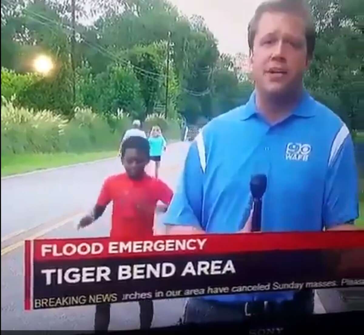 A young boy danced behind a news reporter from WAFB, a CBS-affiliate in Baton Rouge, during a broadcast Aug. 14, 2016.