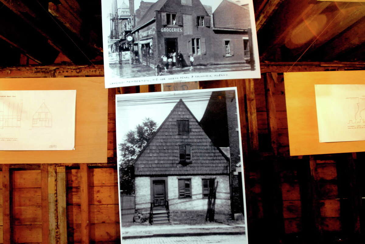 CINDY SCHULTZ/TIMES UNION -- View of photos on display inside 48 Hudson Ave. on Tuesday, Dec. 16, 2008, at 48 Hudson Ave. in Albany, N.Y. The lower photo resembles the Van Ostrande-Radliff House, a Dutch-style home built around 1720 that is one of the oldest homes in the region. (WITH GRONDAHL STORY)