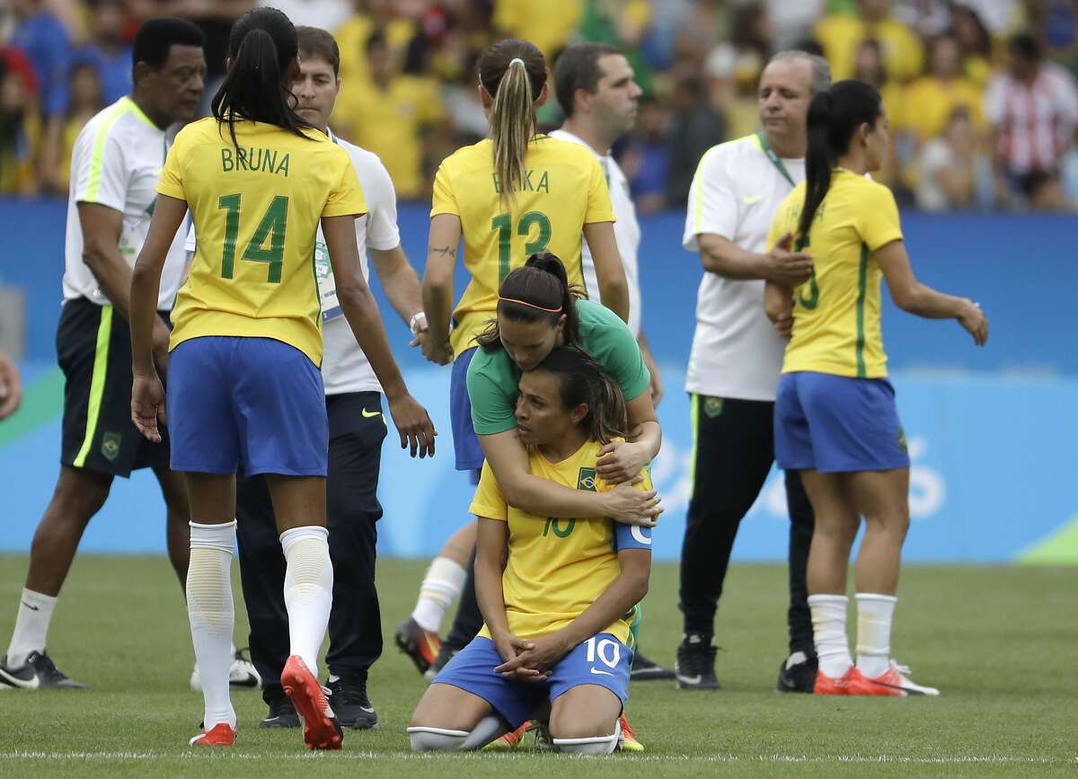 Brazil's Marta is comforted after the penalty kicks during a semi-final match of the women's Olympic football tournament between Brazil and Sweden at the Maracana stadium in Rio de Janeiro Tuesday Aug. 16, 2016. Sweden qualified for the final after beating Brazil on a penalty shoot-out.(AP Photo/Natacha Pisarenko)