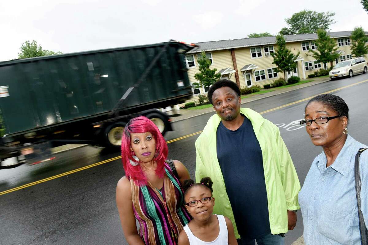 Residents Deneed Carter-El, left, her daughter Tatiyana Carter-El, 8, and Tammy Miller, right, join Brett Taylor, whose mother is a resident, on Tuesday, Aug. 16, 2016, at Ezra Prentice Homes in Albany, N.Y. They are all concerned about oil trains and heavy diesel tractor-trailer traffic. (Cindy Schultz / Times Union)