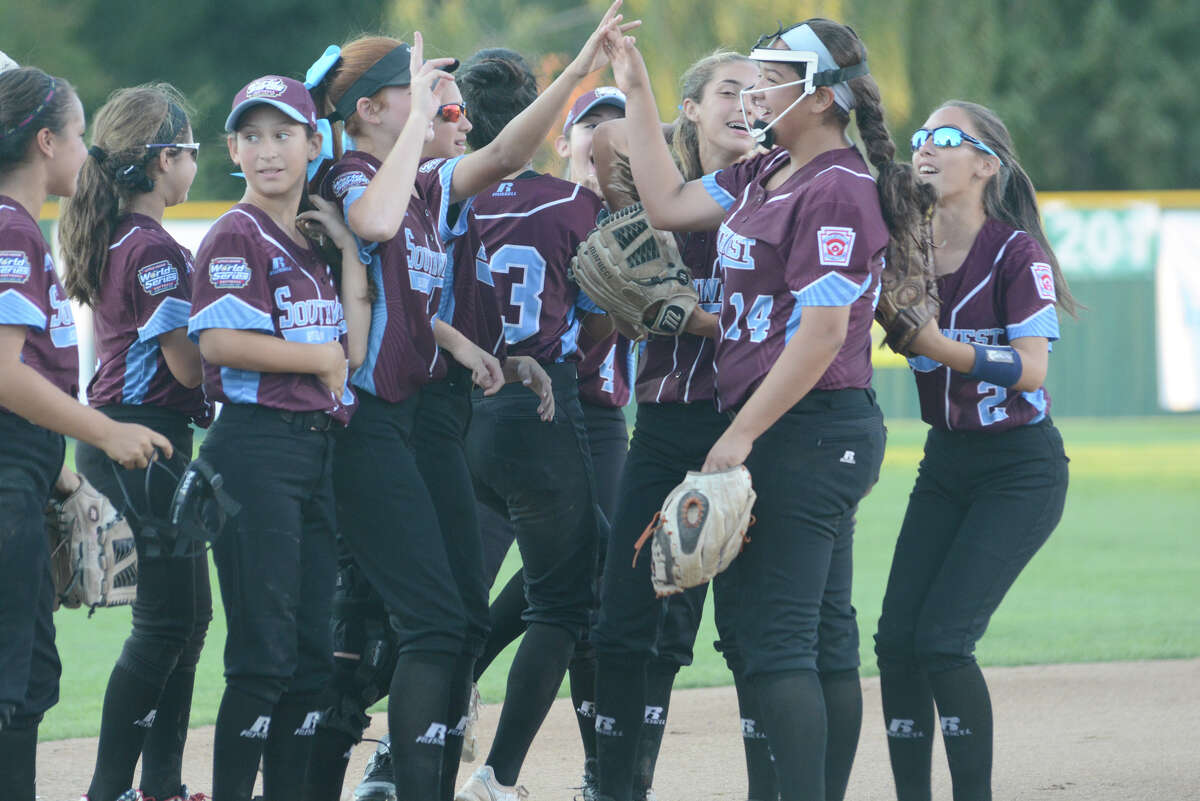The Greater Helotes team celebrates after Annika Litterio strikes out the final batter to complete Tuesday’s 6-0 semifinal win over Grandville, Mich.