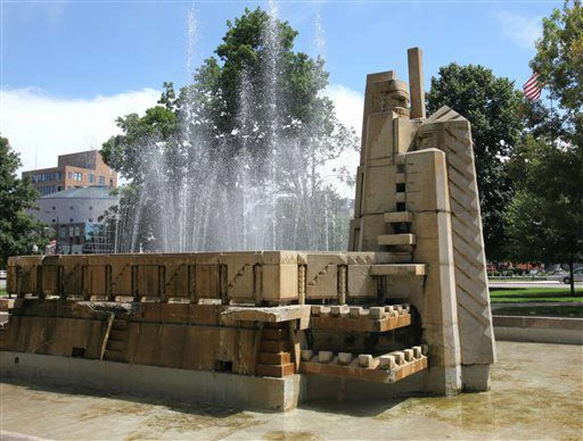 This July 11, 2016 photo shows the Fountain of the Pioneers in Bronson Park in Kalamazoo, Mich. The fountain, that's been criticized for its depiction of a Native American and a settler has been given its own listing on the National Register of Historic Places. (Mark Bugnaski/Kalamazoo Gazette-MLive Media Group via AP)