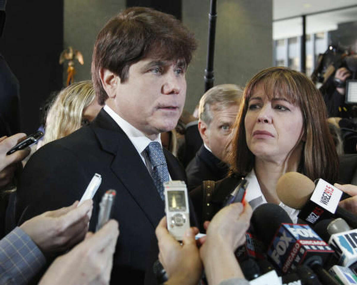 In this Dec. 7, 2011 file photo, former Illinois Gov. Rod Blagojevich, left, speaks to reporters as his wife, Patti, listens at the federal building in Chicago.A federal judge will decide Tuesday, Aug. 9, 2016, whether to cut the 14-year prison term given to Blagojevich after he was convicted of corruption, including charges that he tried to exchange an appointment to President Barack Obama's old U.S. Senate seat in exchange for campaign donations. (AP Photo/M. Spencer Green)