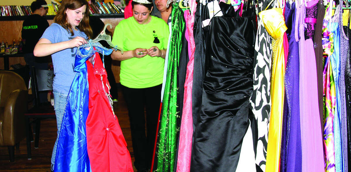 Madison Hubert (left), a sophomore at Laker High School, looks over her dress options with Kathleen Little during Sunday’s portion of Kat’s Cinderella Project at the Green Clean Bean in Bad Axe.