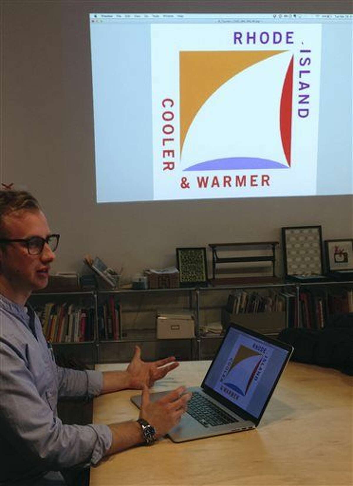 Greg Nemes, of the design firm Work-Shop, displays the new logo for a campaign to attract tourism and business to Rhode Island, during an interview with The Associated Press in The Design Office, Tuesday, March 29, 2016, in Providence, R.I. The state released the logo this week, created by Milton Glaser, whose past work includes the iconic "I Love NY" logo. (AP Photo/Michelle R. Smith)