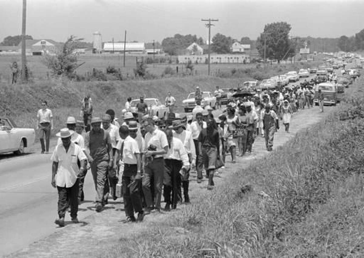 In this June 9, 1966 file photo, civil rights activists led by Dr. Martin Luther King stretch out along Highway 51 south near Senatobia, Miss., on a march to the capital, Jackson, started by James Meredith. The March Against Fear helped many find a voice to protest the injustices of the day. (AP Photo)