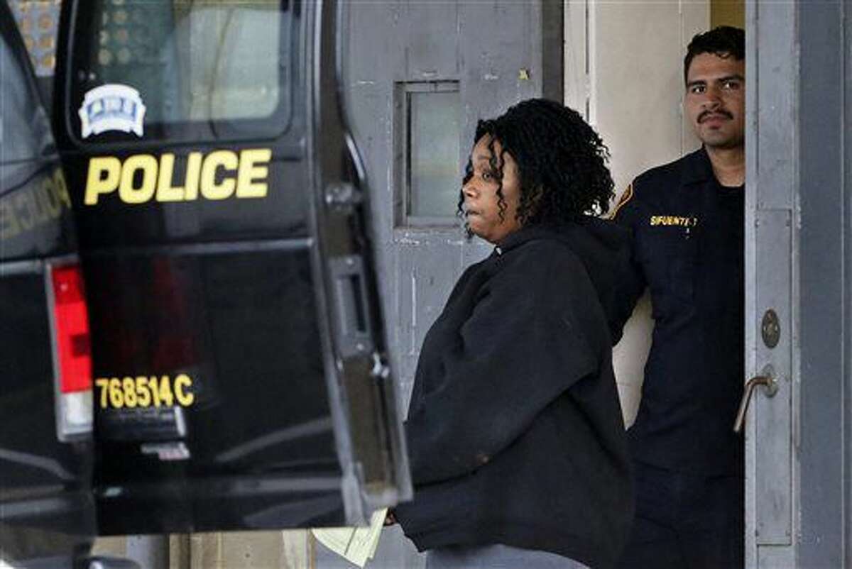 Porucha Phillips is taken from the magistrate's office in a San Antonio Police Department transport vehicle, Friday, April 29, 2016. Phillips, 34, was charged with two counts of injury to a child by omission. Her bond was set at $75,000 on each charge, according to the website of the Bexar County Magistrate. (Tom Reel/San Antonio Express-News via AP)