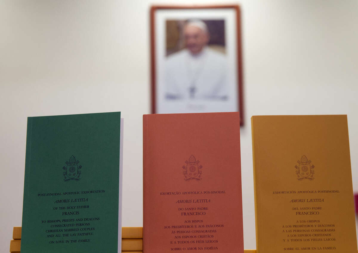 Copies of the post-synodal apostolic exhortation ' Amoris Laetitia ' (The Joy of Love) document are on display prior to the start of a press conference, at the Vatican, Friday, April 8, 2016. Pope Francis has insisted that individual conscience be the guiding principle for Catholics negotiating the complexities of sex, marriage and family life in a major document released Friday that repudiates the centrality of black and white rules for the faithful. In the 256-page document "The Joy of Love," released Friday, Francis makes no change in church doctrine. (AP Photo/Andrew Medichini)