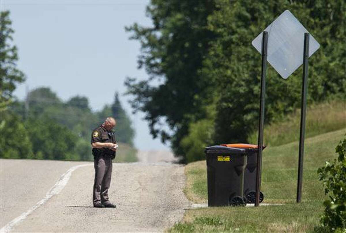 A member of the Kent County Sheriff's Department investigates after a woman was found dead in Gaines Township, Mich., Friday, June 17, 2016. Police said the death is being treated as suspicious. (Cory Morse/The Grand Rapids Press via AP) ALL LOCAL TELEVISION OUT; LOCAL TELEVISION INTERNET OUT; MANDATORY CREDIT