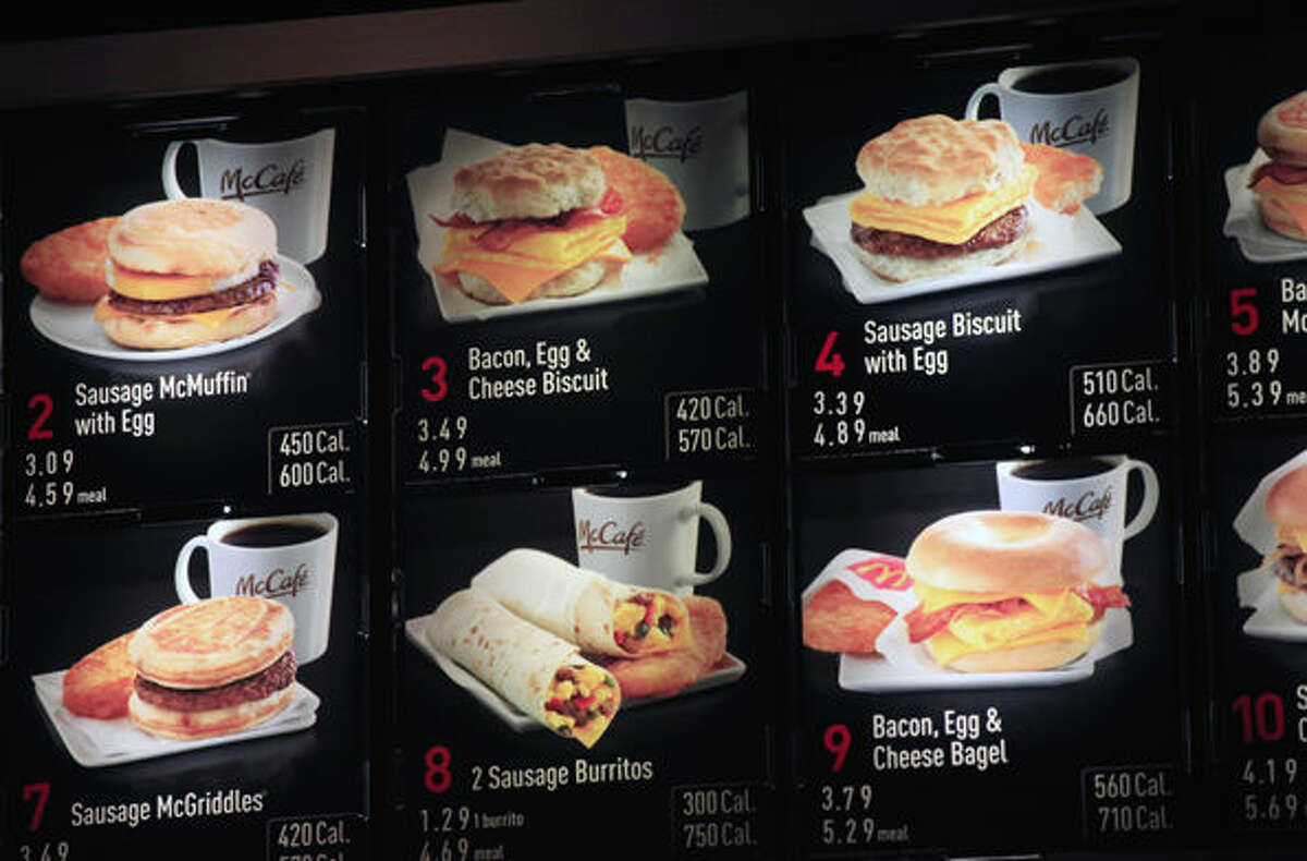 FILE - In this Sept. 12, 2012 file photo, items on the breakfast menu, including the calories, are posted at a McDonald's restaurant in New York. Wondering how many calories are in that hamburger? Chain restaurants still don't have to tell you, despite a six year-old law requiring calorie labels. The Food and Drug Administration said earlier this month that it will delay menu labeling rules, again, until next year. Pushback from supermarkets and convenience stores that will be required to put calorie labels on take-out foods have slowed the process. (AP Photo/Mark Lennihan, File)
