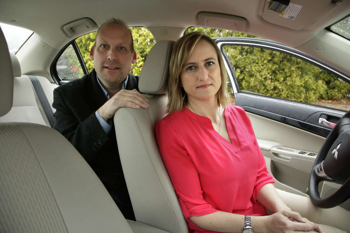 In this Thursday, April 7, 2016 photo Michael Pelletz, left, and Kelly Pelletz, both of Charlton, Mass., who together created the ride-sharing service Chariot for Women, sit for a photograph in their car, in Charlton, Mass. The husband and wife entrepreneurs are launching the service this summer, featuring female drivers who will pick-up solely women and children passengers. (AP Photo/Steven Senne)