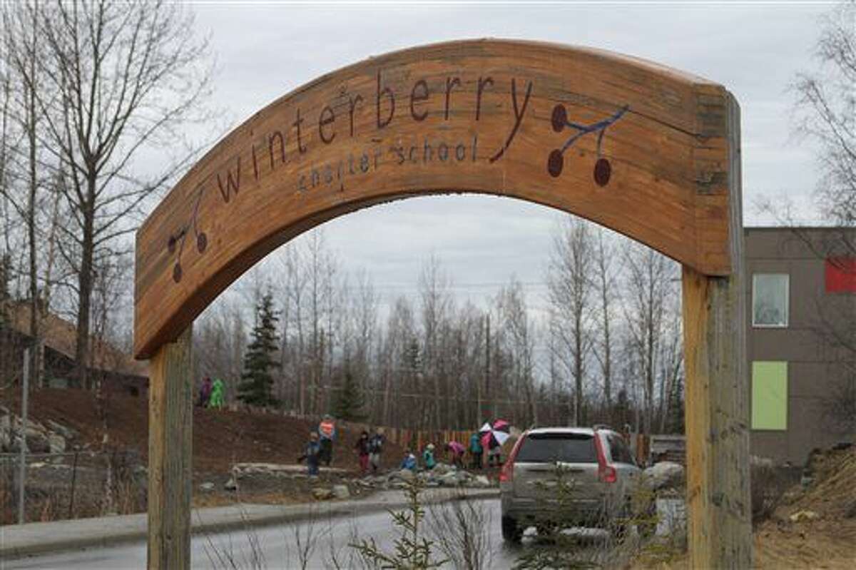 Children play outside Winterberry Charter School in Anchorage, Alaska, Wednesday, March 30, 2016. Three first-graders in Alaska's largest city plotted to kill a fellow student with silica gel packets that the girls believed was poison and have been disciplined but not charged with any crime, authorities said Wednesday. (AP Photo/Mark Thiessen)