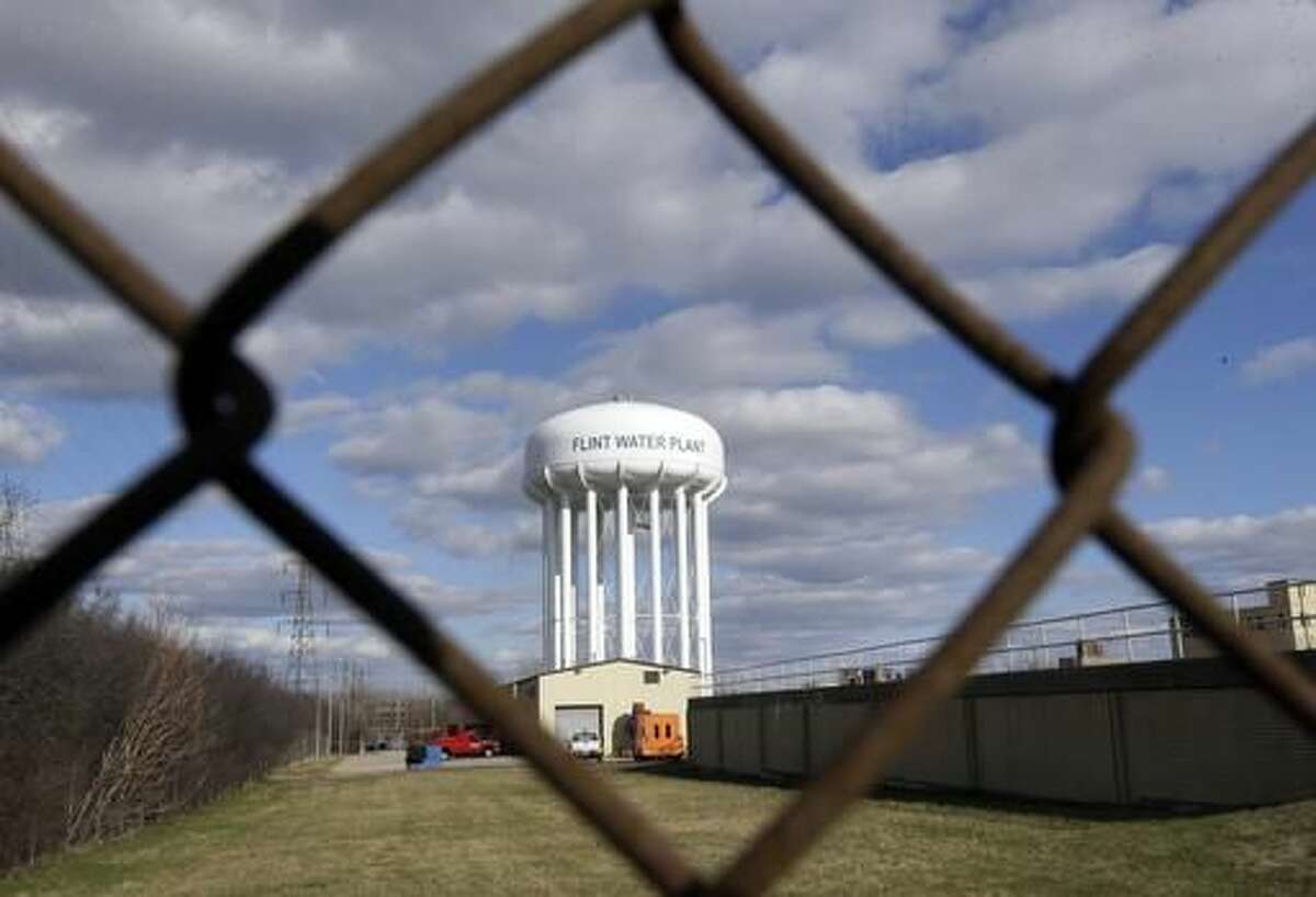 FILE - This March 21, 2016 file photo shows the Flint Water Plant water tower in Flint, Mich. Michigan Gov. Rick Snyder is calling for a halt of administrative investigations into how two state agencies dealt with the Flint drinking water crisis after being warned they are hampering state and federal criminal probes. Snyder's office released letters Thursday May 26, 2016, from the state attorney general and a federal prosecutor. (AP Photo/Carlos Osorio File)