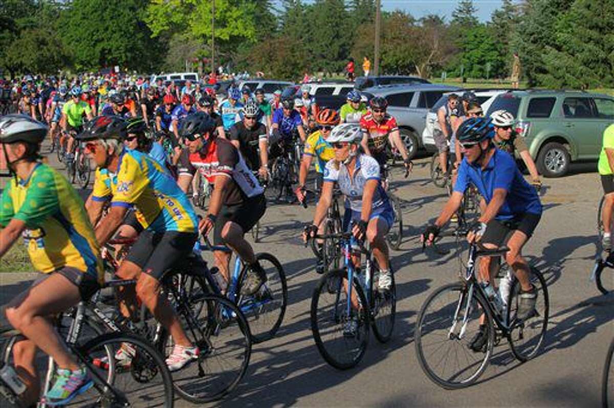 Hundreds of area cyclist leave the Kalamazoo County Health and Community Services parking lot for a ride in Kalamazoo, Mich., Tuesday, June 14, 2016. Cyclists took a 28.5-mile ride in southwestern Michigan to honor five bicyclists who were killed when they were hit by a pickup truck. (Mark Bugnaski/Kalamazoo Gazette-MLive Media Group via AP)