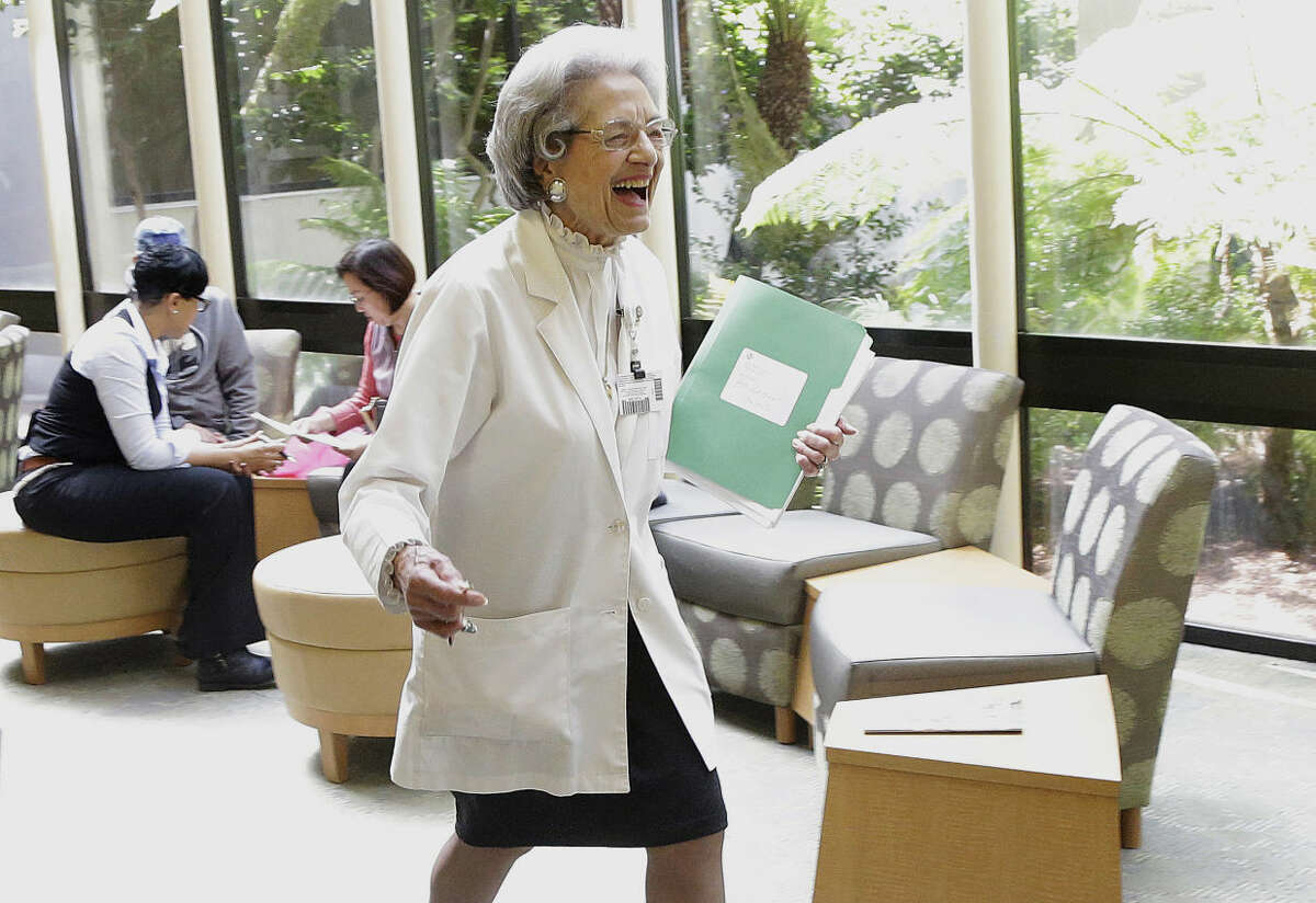 Patient relations representative Elena Griffing smiles while walking in the lobby at Sutter Health Alta Bates Summit Medical Center in Berkeley, Calif., Monday, April 11, 2016. Griffing, 90, has started her 70th year working for the same San Francisco Bay Area hospital. (AP Photo/Jeff Chiu)