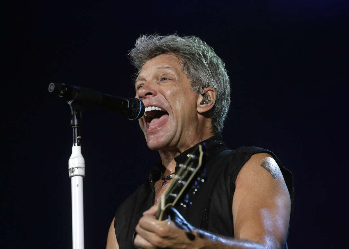 FILE - In this Sept. 11, 2015 file photo, Bon Jovi's lead singer Jon Bon Jovi performs during their "Bon Jovi Live!" concert at Gelora Bung Karno Stadium in Jakarta, Indonesia, on their Asia tour. A New Jersey woman battling lung cancer has received an unforgettable surprise from one of the state's most famous rockers, Bon Jovi. Rosie Skripkunis says her mother, Carol Cesario, is a lifelong fan of Bon Jovi and has always wanted to meet him. Last month, Skripkunis shared a sign on social media asking the singer to visit her mother. Bon Jovi surprised Cesario at his Toms River restaurant on Saturday, June 25, 2016, with an autographed guitar and a kiss. (AP Photo/Tatan Syuflana, File)