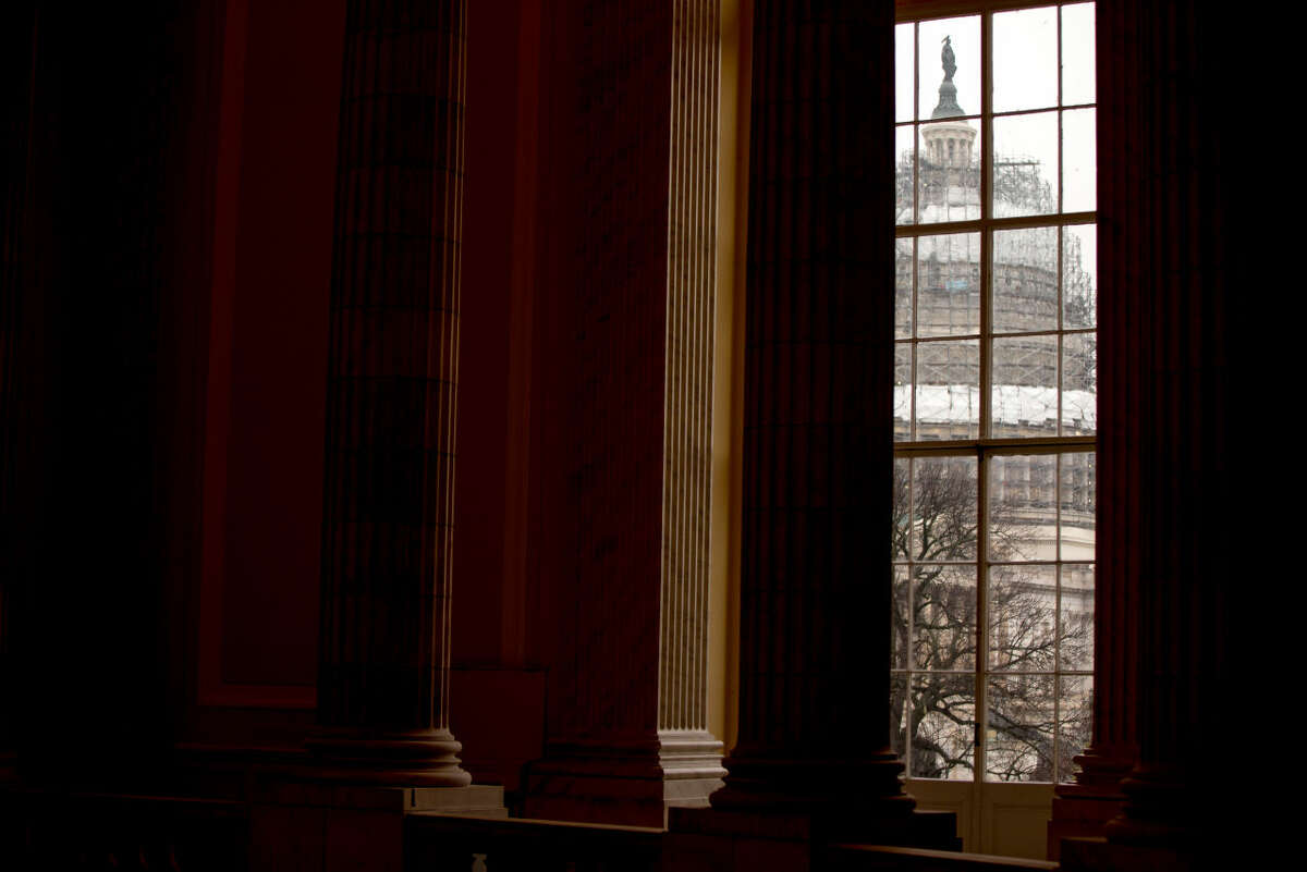 In this photo taken Feb. 9, 2016, The Capitol Dome is visible through a window in the Cannon House Office Building on Capitol Hill in Washington. An Associated Press-GfK poll finds that most Americans are happy with their friends and family, feel good about their finances and are more or less content at work. It’s government, particularly the federal government, that’s making them see red. (AP Photo/Andrew Harnik)