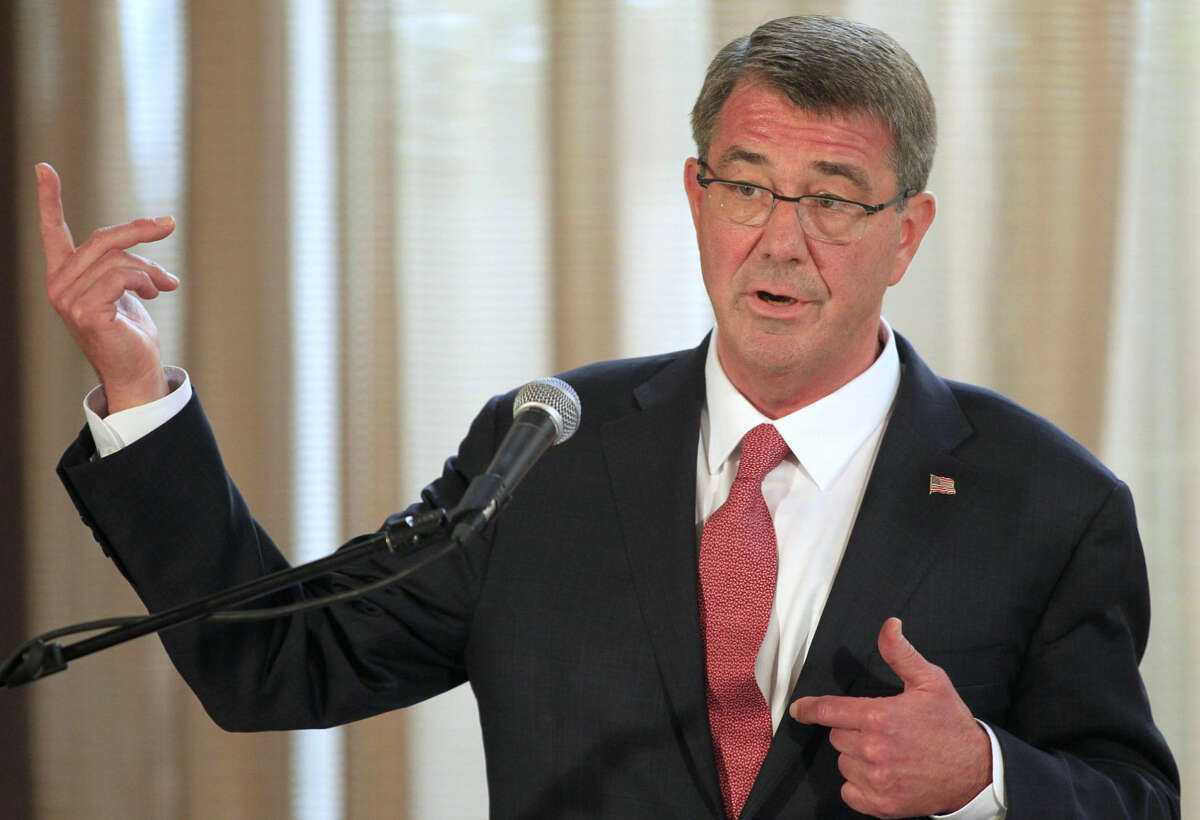 FILE - In this April 14, 2016 file-pool photo, Defense Secretary Ash Carter gestures during a news conference in Manila, Philippines. Carter said he will talk with his commanders in the coming days to identify more ways the U.S. can intensify the fight against Islamic State militants in Iraq and Syria, including more airstrikes, cyberattacks, and American troops on the ground. (Romeo Ranoco/Pool Photo via AP, File)