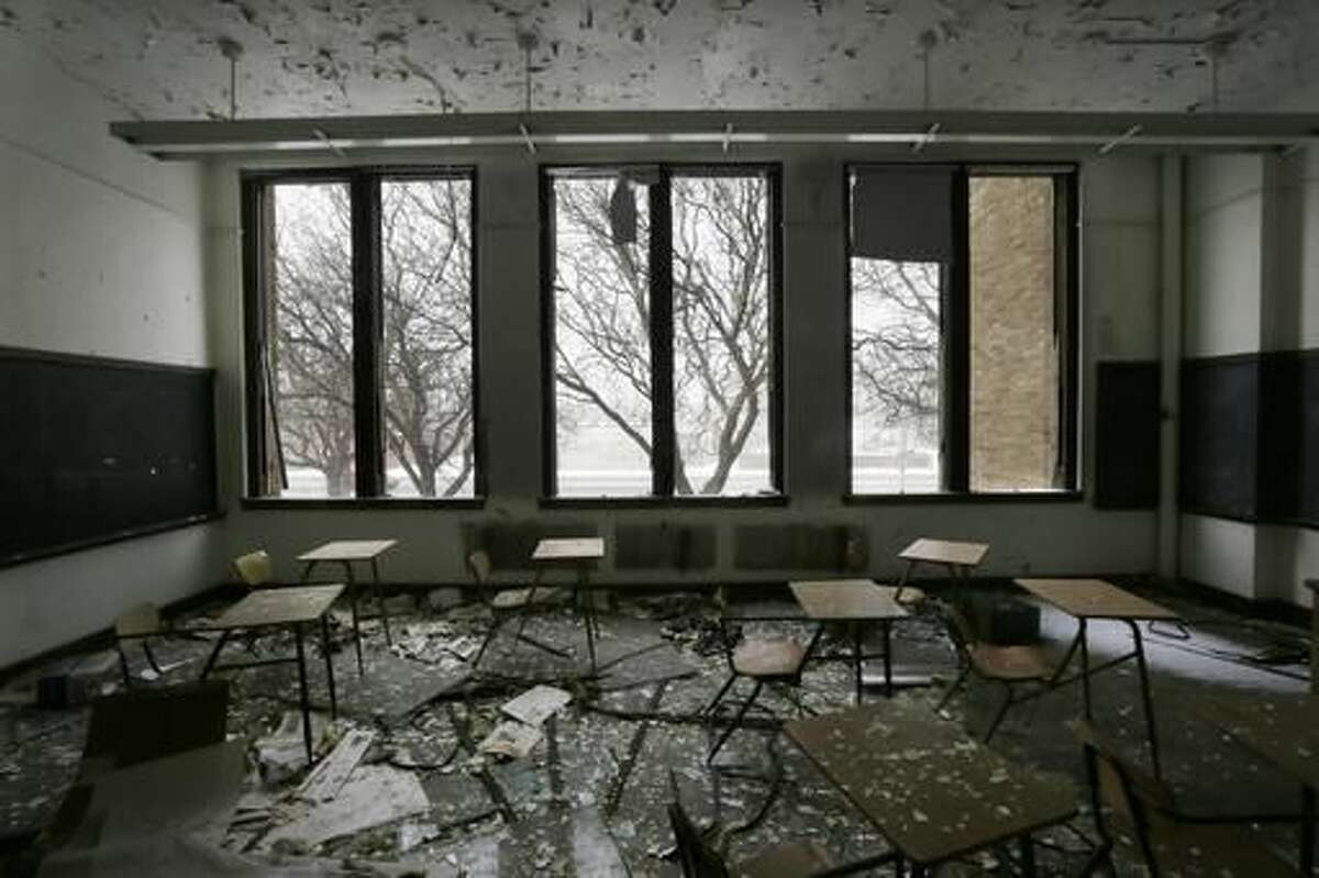 This file photo from Jan. 6, 2015, shows a vacant classroom at Southwestern High School in Detroit. Michigan lawmakers trying to glue together a plan to fix Detroit Public Schools using taxpayer money are staring down more than a decade of failure with what was once among the largest public education systems in the nation. (AP Photo/Carlos Osorio)