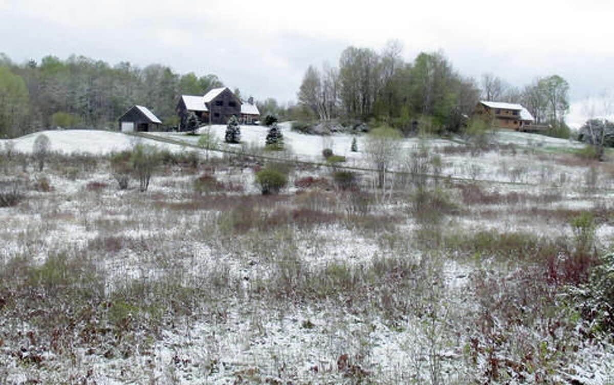 A dusting of snow covers Perry Hill in Waterbury, Vt., on Monday May 16, 2016, a month before the official start of summer. The National Weather Service said 3.4 inches of snow were recorded in far north Caribou, Maine early Monday, setting a record for the most snow there this late in May. (AP Photo/Wilson Ring)