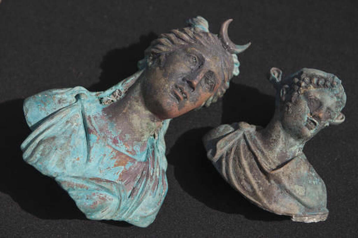 Rare bronze artifacts, part of a large ancient marine cargo of a merchant ship that sank during the Late Roman period 1,600 years ago are seen during a presentation of the Israel Antiquities Authority in Caesarea, Israel, Monday, May 16, 2016. Israeli archeologists say two divers have made the country' biggest discovery of Roman-era artifacts in three decades. (AP Photo/Dan Balilty)