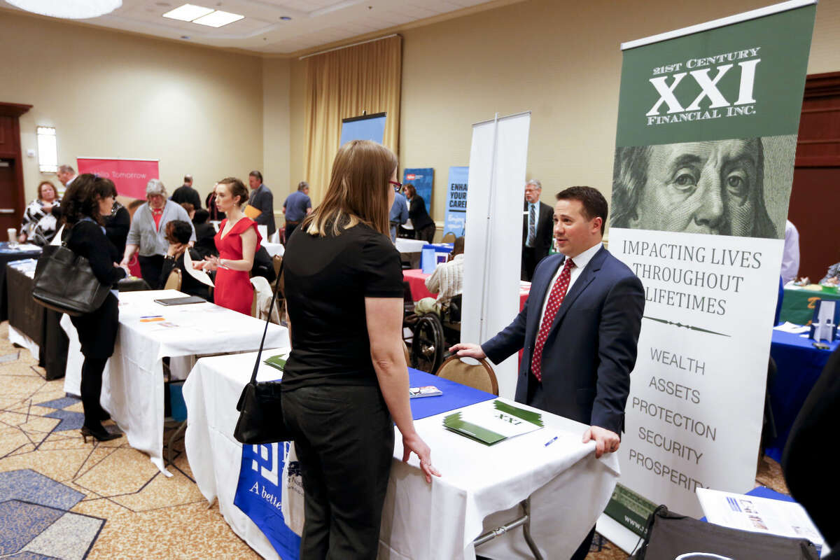 In this Wednesday, March 30, 2016, photo, companies speak with job seekers at a job fair in Pittsburgh. On Thursday, April 21, 2016, the Labor Department reports on the number of people who applied for unemployment benefits the week before. (AP Photo/Keith Srakocic)