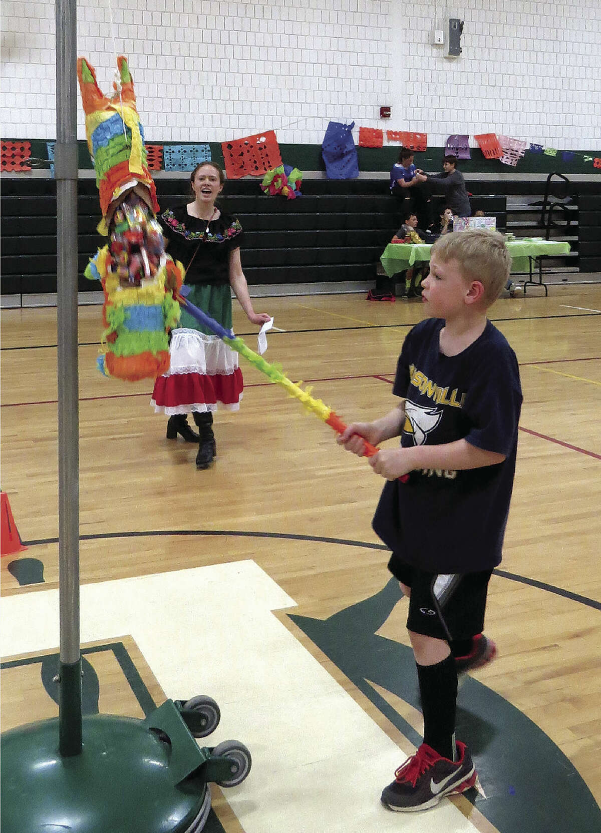 Noah Adams cracks open one of the piñatas like a pro during the event at Laker Schools.  (Submitted Photo)