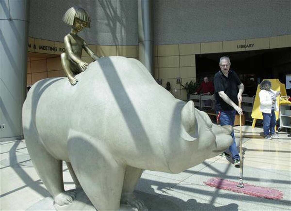 "The Boy and Bear" sculpture by artist Marshall Frederick was relocated to the Southfield Public Library, Friday May 6, 2016. in Southfield, Mich. The Southfield Public Arts Commission raised funds recently to acquired the scupture from the former Northland Center. (Mandi Wright/Detroit Free Press via AP)