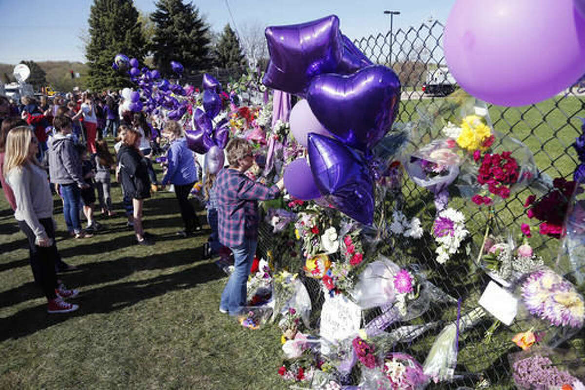 A memorial fence in memory of pop star Prince is lined with flowers and signs at Paisley Park Studios Friday, April 22, 2016 in Chanhassen, Minn. Prince died Thursday at Paisley Park at the age of 57. (AP Photo/Jim Mone)