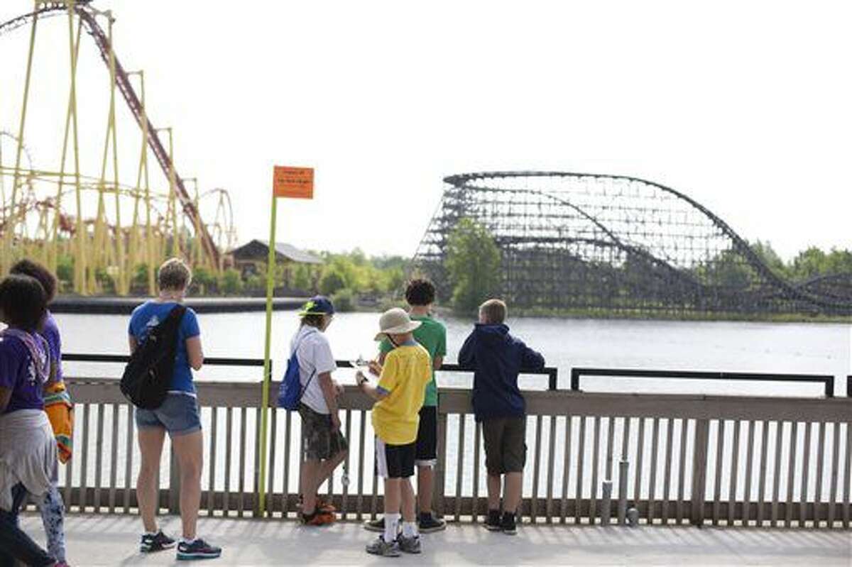 Students work on physic problems that are placed around the park during physics day at Michigan's Adventures in Muskegon, Mich. on May 25, 2016. More than 450 students from 12 schools had the opportunity to spend the day applying mathematics, physics and measuring skills to solve problems in a real-world setting at Michigan's Adventure. (Emily Brouwer/Muskegon Chronicle via AP) 