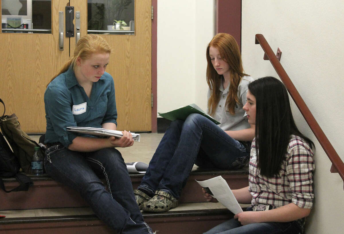 In this April 23, 2016, from left, Laura Johnson, Shea Moshier, and Ilsa Johnson, members of a 4-H team from Duluth, Minn., prepare for their presentation at the University of Minnesota in St. Paul on how drones could protect livestock from predators. They are taking part in the 4-H Science of Agriculture Challenge, which aims to nurture the next generation of agricultural scientists for a country facing a critical shortage of them. (Allison Sandve/University of Minnesota Extension via AP)