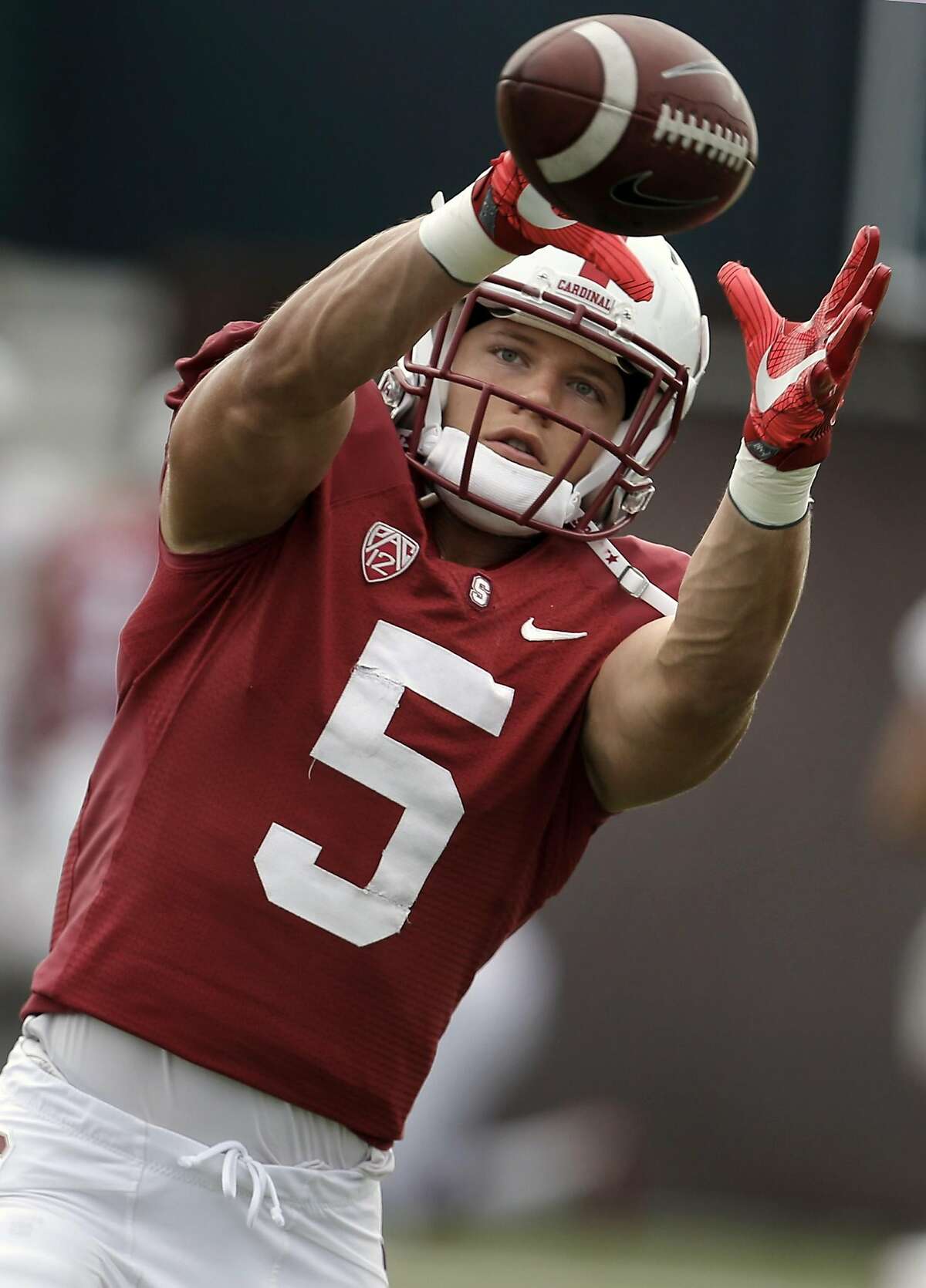 Stanford's Christian McCaffrey fighting against white running back