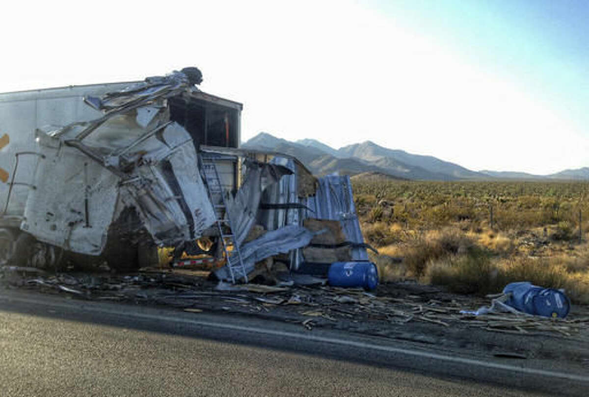 This photo provided by San Bernardino County Fire District shows the remains of a semi-truck that crashed on a remote stretch of Interstate 15 in the Southern California desert near the Nevada border on Wednesday, Aug. 3, 2016. The California Highway Patrol says the interstate was closed for hours in both directions following the crash. ( John Miller/San Bernardino County Fire District via AP)