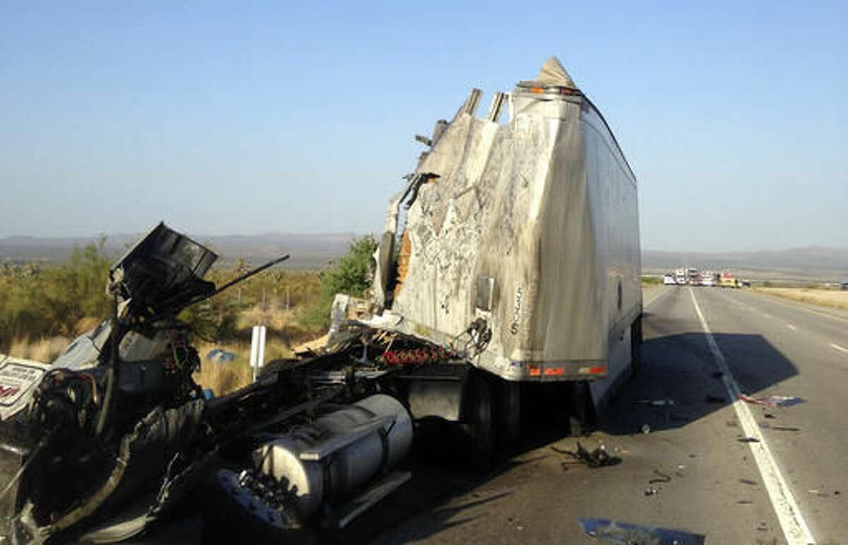 This photo provided by San Bernardino County Fire District shows the remains of a semi-truck on a remote stretch of Interstate 15 in the Southern California desert near the Nevada border on Wednesday, Aug. 3, 2016. The California Highway Patrol says the interstate was closed for hours in both directions following the crash. ( John Miller/San Bernardino County Fire District via AP)
