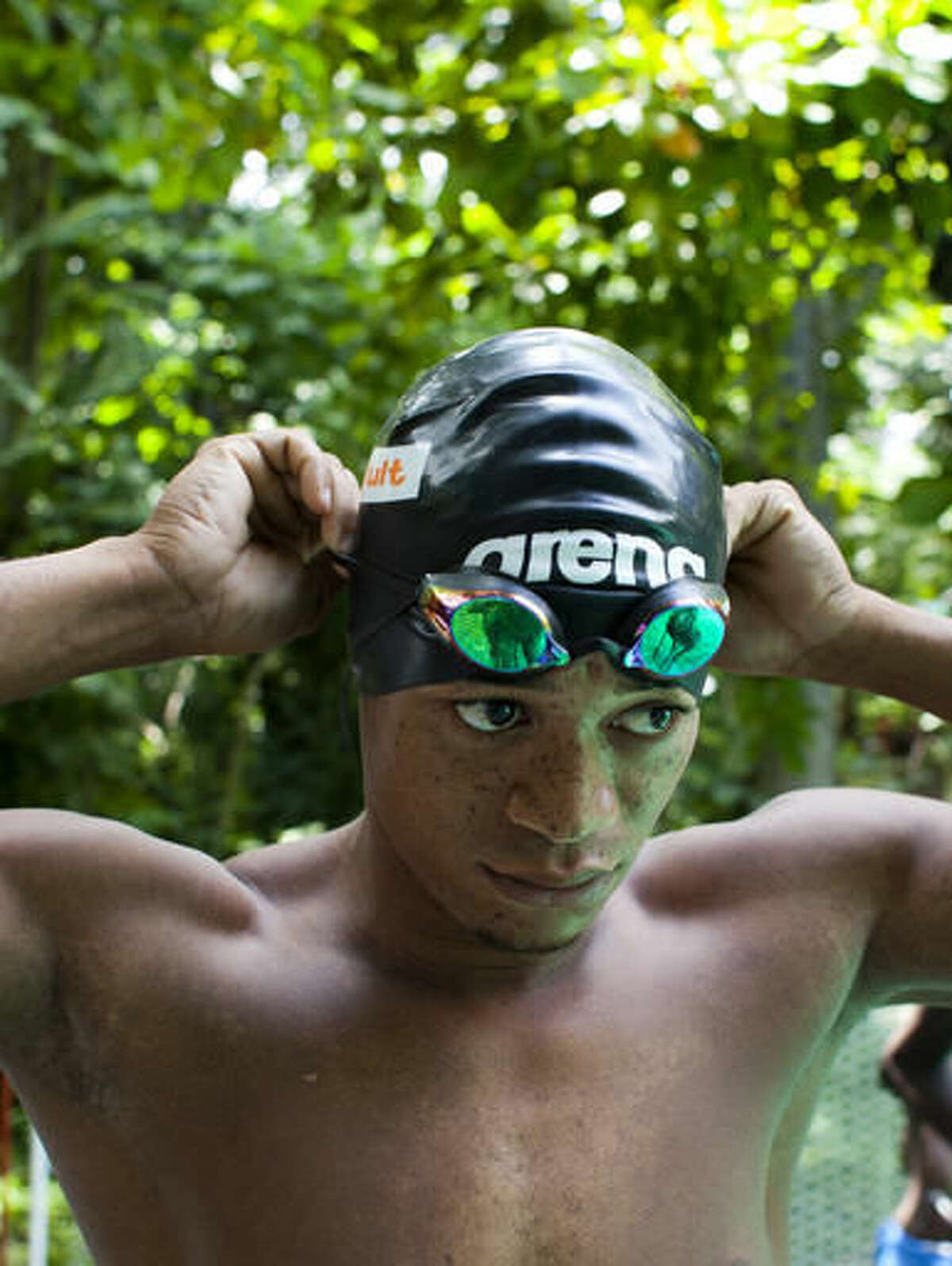 In this July 21, 2016 photo, Haitian Olympic swimmer Frantz Mike Itelord Dorsainvil readies for a day of training in preparation for the Rio Summer Olympic Games, at a private swimming pool in the Port-au-Prince neighborhood Carrefour, Haiti. The lanky 25-year-old swimmer who only began to swim competitively six years ago is aiming to win a medal in the Rio Olympics. (AP Photo/Dieu Nalio Chery)