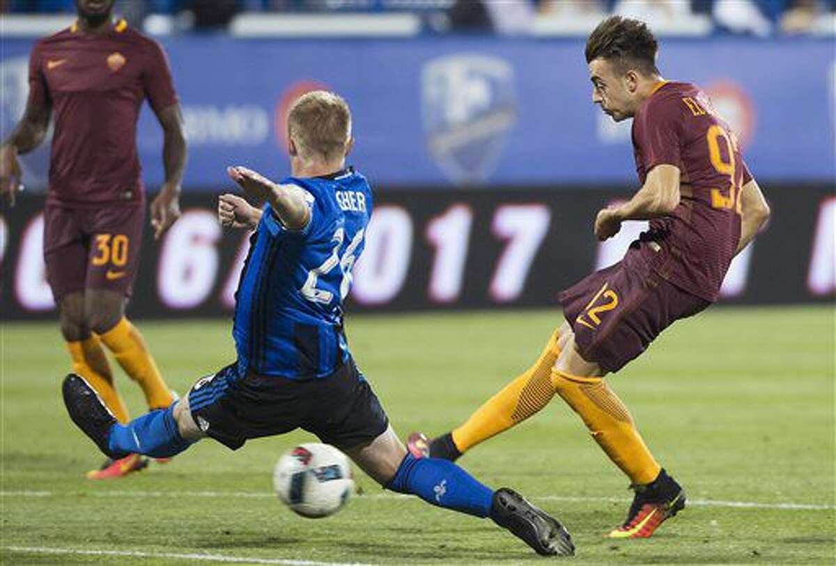Montreal Impact's Kyle Fisher, left, challenges AS Roma's Stephan El Shaarawy during the second half of a friendly soccer match in Montreal, Wednesday, Aug. 3, 2016. (Graham Hughes/The Canadian Press via AP)