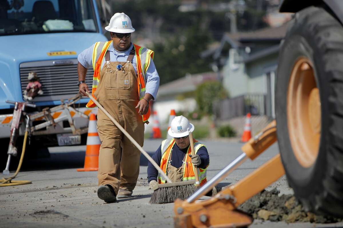 FILE-- PG&E workers dig up the intersection of Glenview and Claremont to place the distribution gas lines, Wednesday August 31, 2011, to the homes that were destroyed in the pipeline explosion in San Bruno.