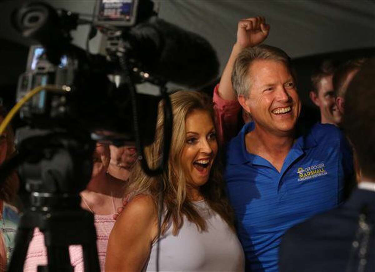 Dr. Roger Marshall and his wife Laina answers question in a television interview during a watch party Tuesday, Aug. 2, 2016, in Great Bend, Kan. The doctor backed by agriculture and business groups has defeated U.S. Rep. Tim Huelskamp in the Republican primary to represent a district spanning much of central and western Kansas. (Travis Morisse/The Hutchinson News via AP)